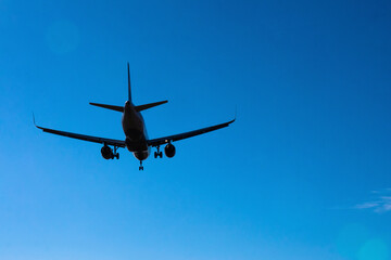 Fototapeta na wymiar Airplane against clear blue sky
