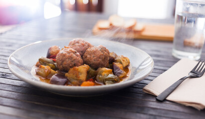 Steamed meatballs with stewed vegetables with haze on plate