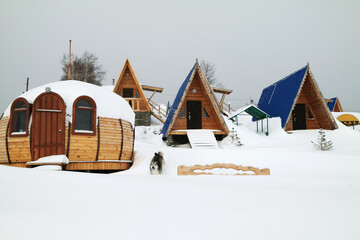 Wooden small houses for rest at coast of frozen lake
