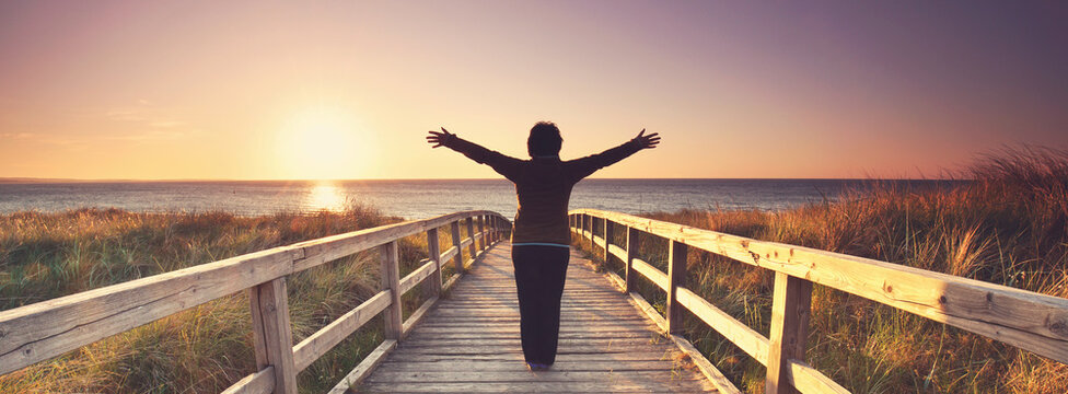 beautiful view at the sea ,senior woman on a wooden jetty at lake