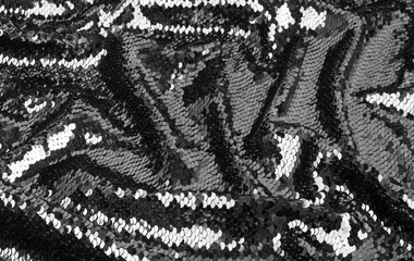 Crumpled of black and white fabric with sequins