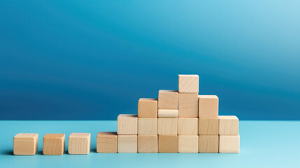 Obraz premium Wooden blocks on a blue background. The concept of growth .
