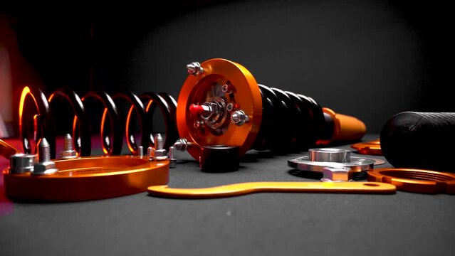 suspension tuning, coilovers, shock absorbers and front springs in yellow and gold colors for a sports drift car on a dark background