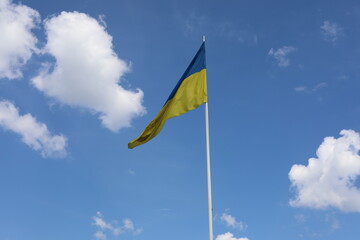Ukrainian flag on blue sky. Country flag against sky. Flags of the world. Peace in the world. Peaceful flag.
