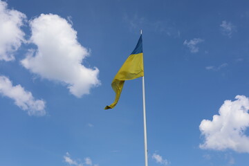 Ukrainian flag on blue sky. Country flag against sky. Flags of the world. Peace in the world. Peaceful flag.

