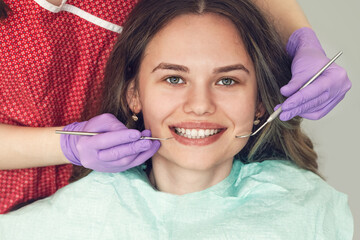 Dentist examining patient teeth in dental clinic during dental control