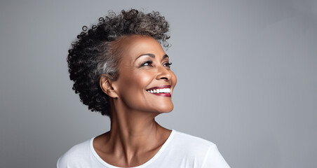African american adult woman with smooth healthy face skin. Beautiful aging mature woman with curle gray hair and happy smiling. Beauty and cosmetics skincare advertising concept. - 723857781