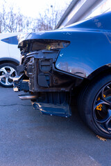 Close-up of a car with damage to the rear bumper after an accident at a service station