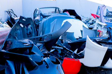 close-up of various metal spare parts from cars at the scrapyard car disposal station