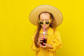Little smiling beautiful blonde curly hair girl in yellow dress, straw hat and summer style...