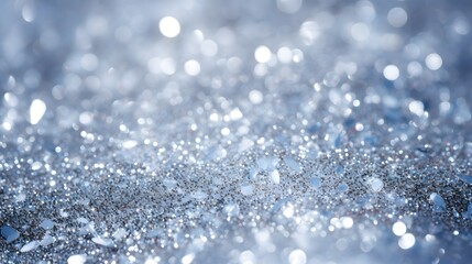 Sparkling or shimmering silver glitter background. Falling silver glitter with intense sparkle. Good christmas and gift season background. Shallow depth of field.