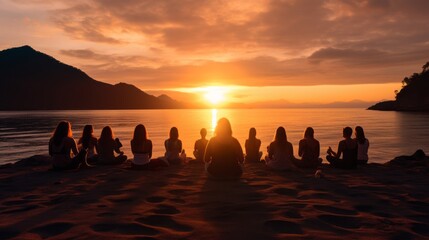Group of young female practicing yoga, meditating on the seaside at sunset. Yoga wellness retreat class.