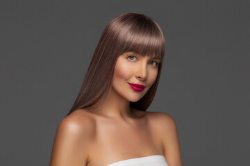Naklejka premium Haircare. Coloring. Shiny and healthy hair. Beauty portrait of young woman with long dyed hairstyle and red lips make up . Care shampoo