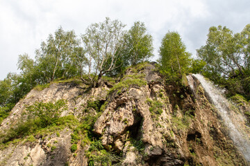 Fototapeta na wymiar Waterfall on a rocky river in the mountains