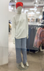 A mannequin in a clothing store window