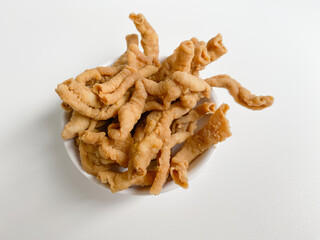 Crispy fried chicken intestines, isolated on white background, flat lay or top view