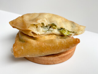 Martabak, made from flour dough, egg and leek slices. Snack from Indonesia. Isolated on white background