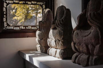 Broken figures of Buddha in a display room
