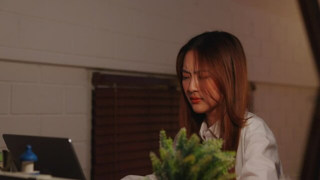 Young asian woman office employee feeling tired, exhausted, fatigue while working on laptop computer overtime at night in home. Businesswoman feel worried about work financial problem in business
