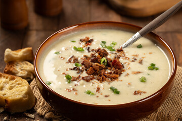 Creamy potato soup with bacon pieces and chopped green onion