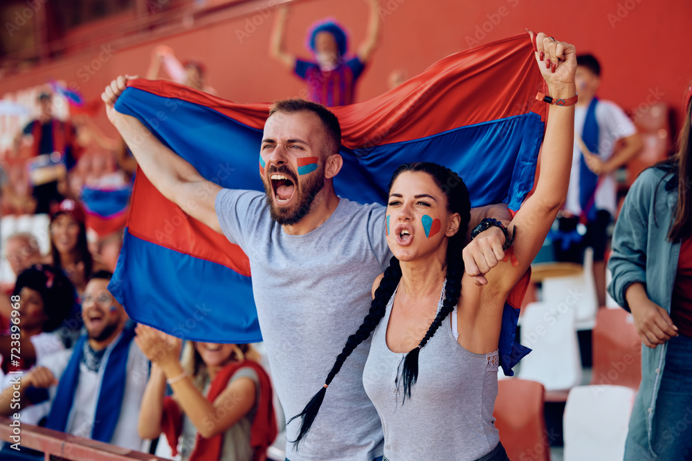 Sticker Passionate sports fans shouting during match at stadium.