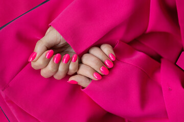 Girl with pink manicure nails on pink background, mockup. Manicure holiday style for a date or for...
