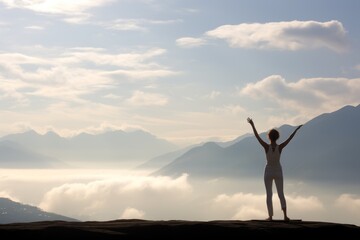 Fototapeta na wymiar Woman in yoga pose standing on a mountain peak, copy space background wallpaper