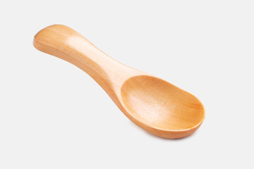 A clean and empty wooden spice spoon isolated on a white background