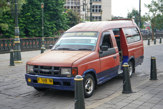 Mikrolet or microbus, which is a public transportation vehicle, is parked waiting for passengers. Public transportation using Toyota Kijang cars. Semarang, Central Java, Indonesia.