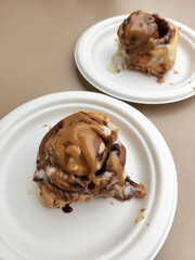 Sweet culinary pastries. Cinnabon in chocolate glaze. Culinary product