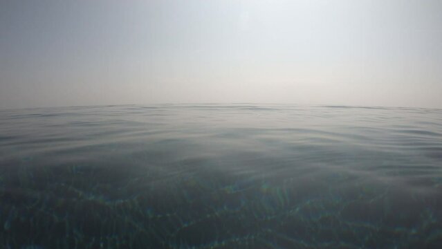 surface of transparent blue water in the swimming pool with blue sky and white cloud, 4K motion scene