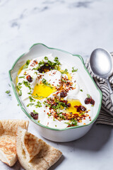 Whipped feta dip with chili, oil and cilantro.