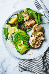 Vegan toasts with avocado and grilled cauliflower, gray marble background. Healthy plant based breakfast.