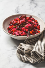 Russian beet vinaigrette salad with green peas, boiled vegetables and dill.