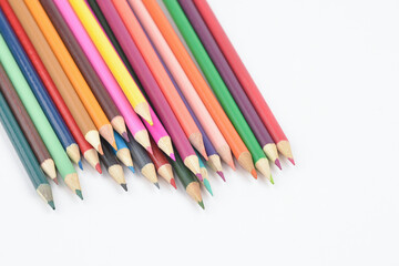 A group of seamless wooden coloured pencils facing down isolated on white background