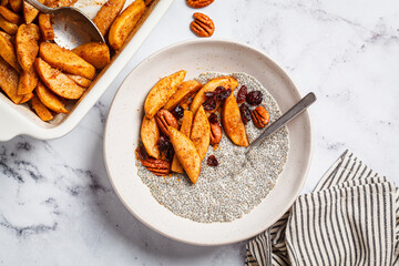Chia pudding with caramelized apples, pecan and cranberries. Winter vegan breakfast recipe.