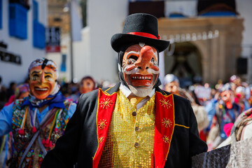 Dancers in traditional costumes celebrate with choreographies the festivity of the Virgen del Carmen in Paucartambo square. Cusco Peru.
