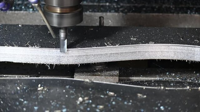 The CNC milling machine cutting press die part by solid bull end mill tool and G-code data background.