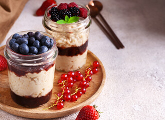 dessert in a jar with jam and fresh berries