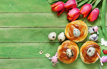 Easter buns and traditional eggs on wooden background