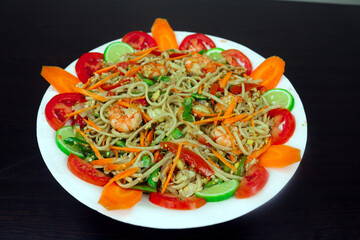 Prawn Noodles Served on a Plate, Beautifully Garnished with Carrots, Tomatoes, and Lemon 