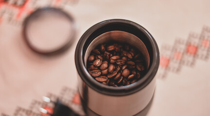 Electric grinder full of coffee beans. The morning drink that wakes you up. Aromatic and flavorful...