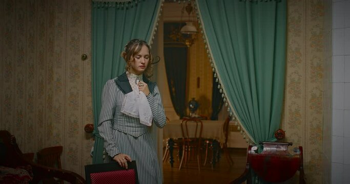 history of 19th century, crying young woman sitting down on chair in retro room, 4K, Prores