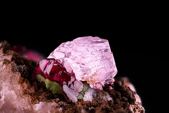 Cobalt-bearing calcite (pink) with roselite, (red) and cobaltoaustinite (green) macro photography detail. From Aghbar mine, Bou Azzer, Morocco
