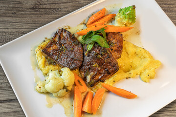 juicy, tender veal liver in sage butter on mashed potatoes and winter vegetables