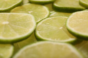 Many juicy lime slices as background, closeup view