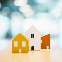 Wooden house model on wood background, a symbol for construction , ecology, loan, mortgage,...