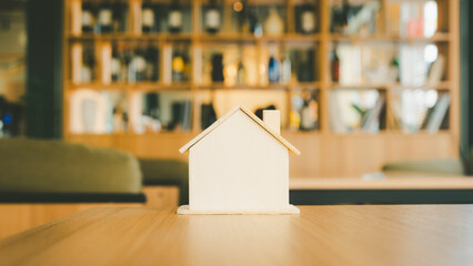 Wooden house model on wood background, a symbol for construction , ecology, loan, mortgage,...