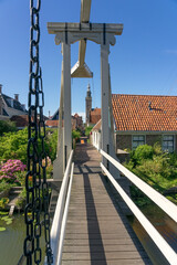Kwakelbrug bridge in the beautiful city of Edam, Netherlands, with its typical houses and the church.