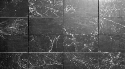 Marble tiles with black and gray colors  with white streaks. Background and texture.